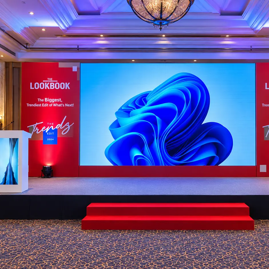 The Lookbook Trendz Edit 2024 launch stage with red branded panels, a large LED screen and red carpet steps by RAW Group
